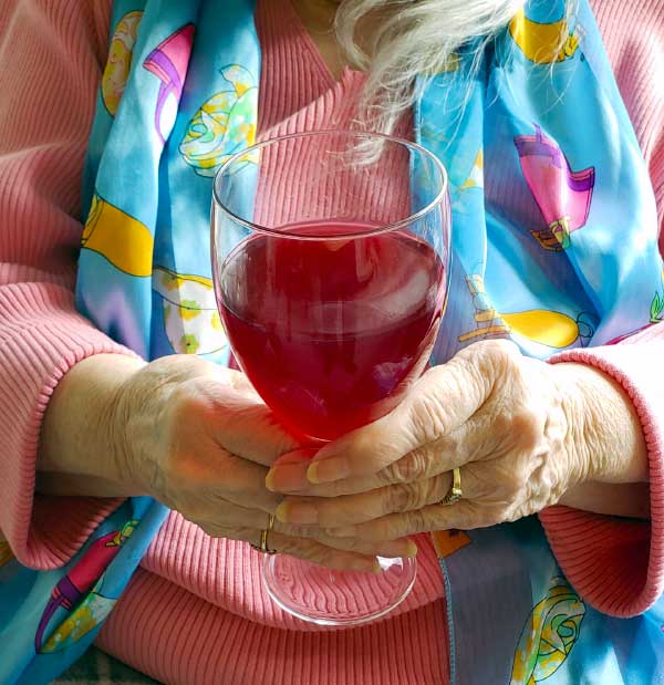Phyllis holding home-made wine